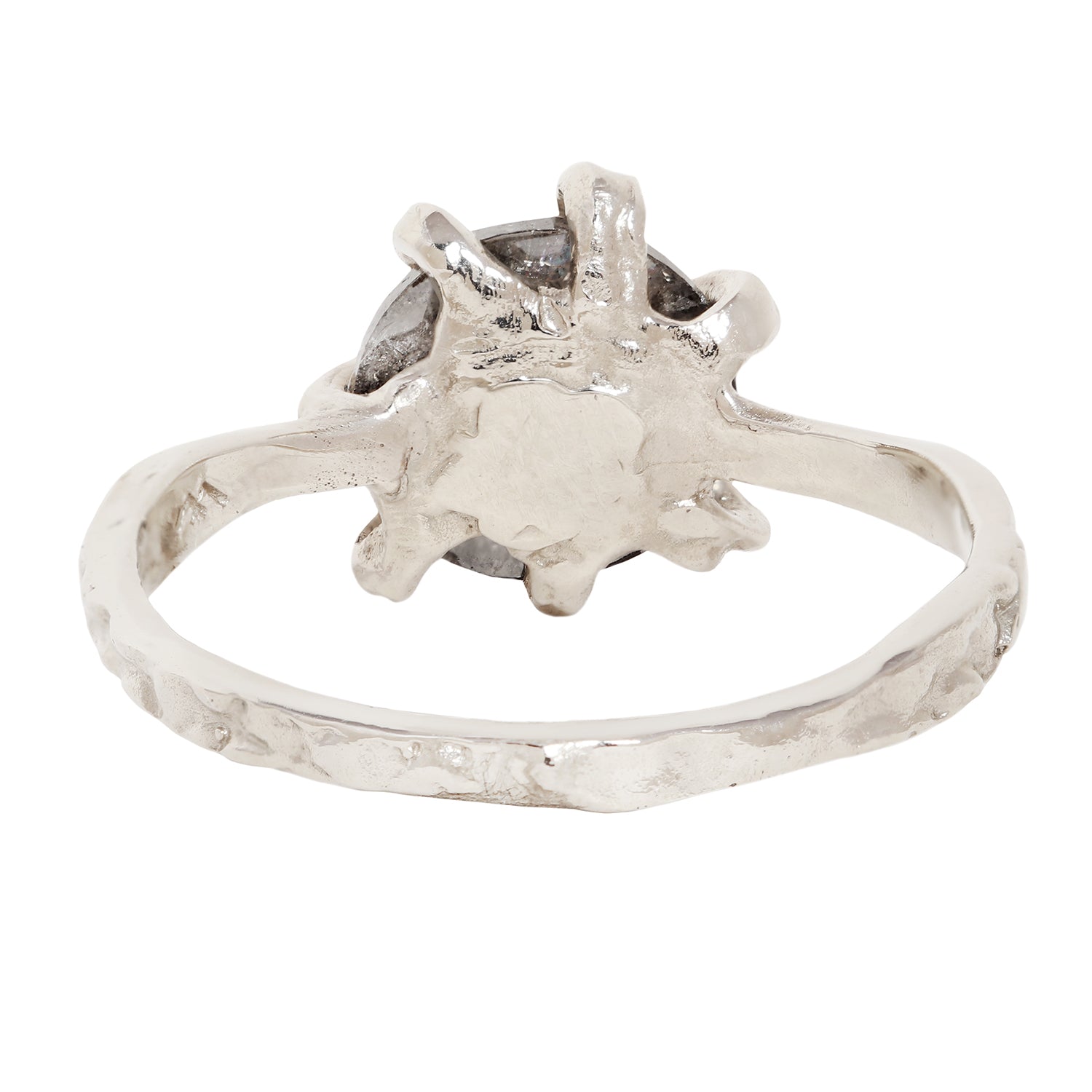 A white gold ring with a textured, organic-shaped setting and a dark gray stone, shown against a plain white background.