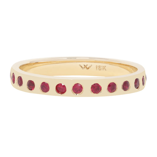 A gold eternity-style ring featuring a row of round-cut deep red gemstones set around the band, shown on a plain white background. The inside of the ring is stamped with a 'W' logo and '18K' gold purity marking.