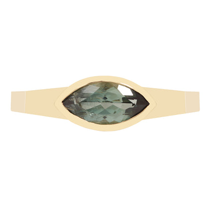 Lauren Wolf - Gold ring with a green gemstone on a white background