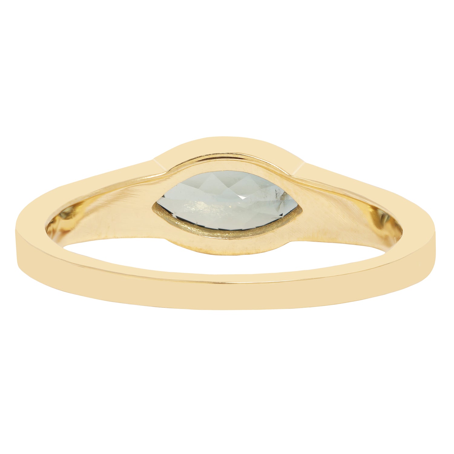 Lauren Wolf - Gold ring with a central gemstone on a white background