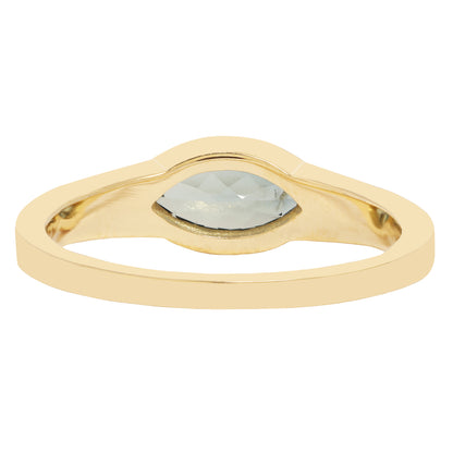 Lauren Wolf - Gold ring with a central gemstone on a white background