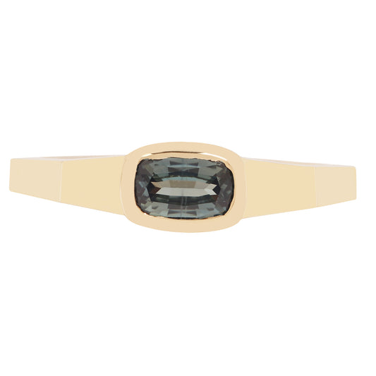 Lauren Wolf - Gold ring with a blue gemstone on a white background