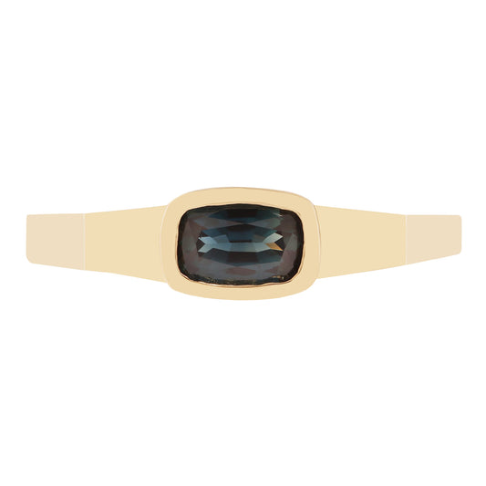 Lauren Wolf - Gold ring with a dark sapphire on a white background