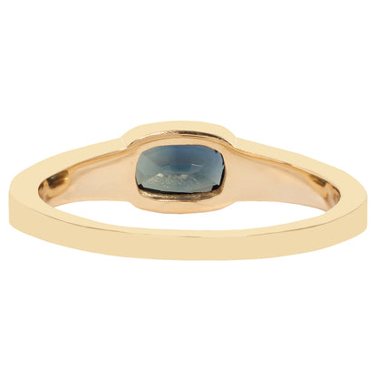 Lauren Wolf - Gold ring with a blue gemstone on a white background