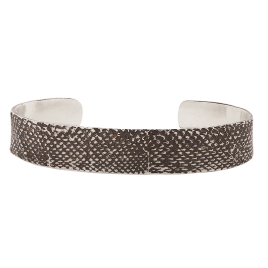 An oxidzed silver bangle with snakeskin texture against a white backdrop Lauren Wolf Jewelry | ESQUELETO 