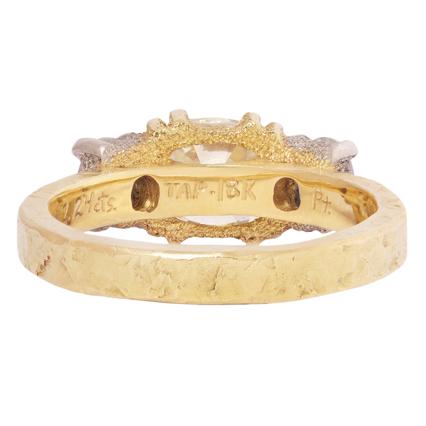 Gold and platinum ring with a central yellow diamond and smaller diamonds on a white background