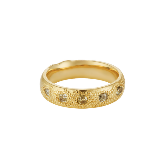 A textured yellow gold band ring featuring a row of small, round-cut green-colored diamonds set along the front, shown against a plain white background.