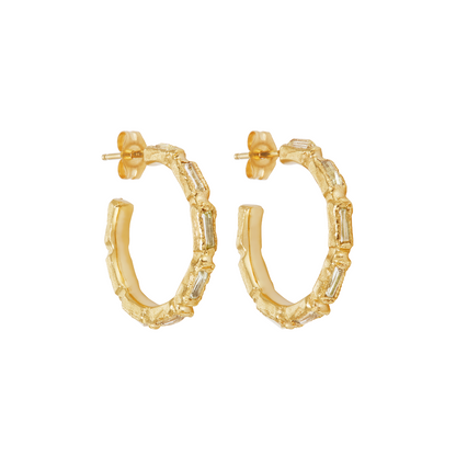 A pair of gold hoop earrings with a textured, segmented design and clear baguette-cut stones, shown on a plain white background.