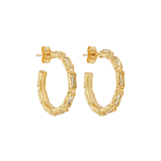 A pair of gold hoop earrings with a textured, segmented design and clear baguette-cut stones, shown on a plain white background.