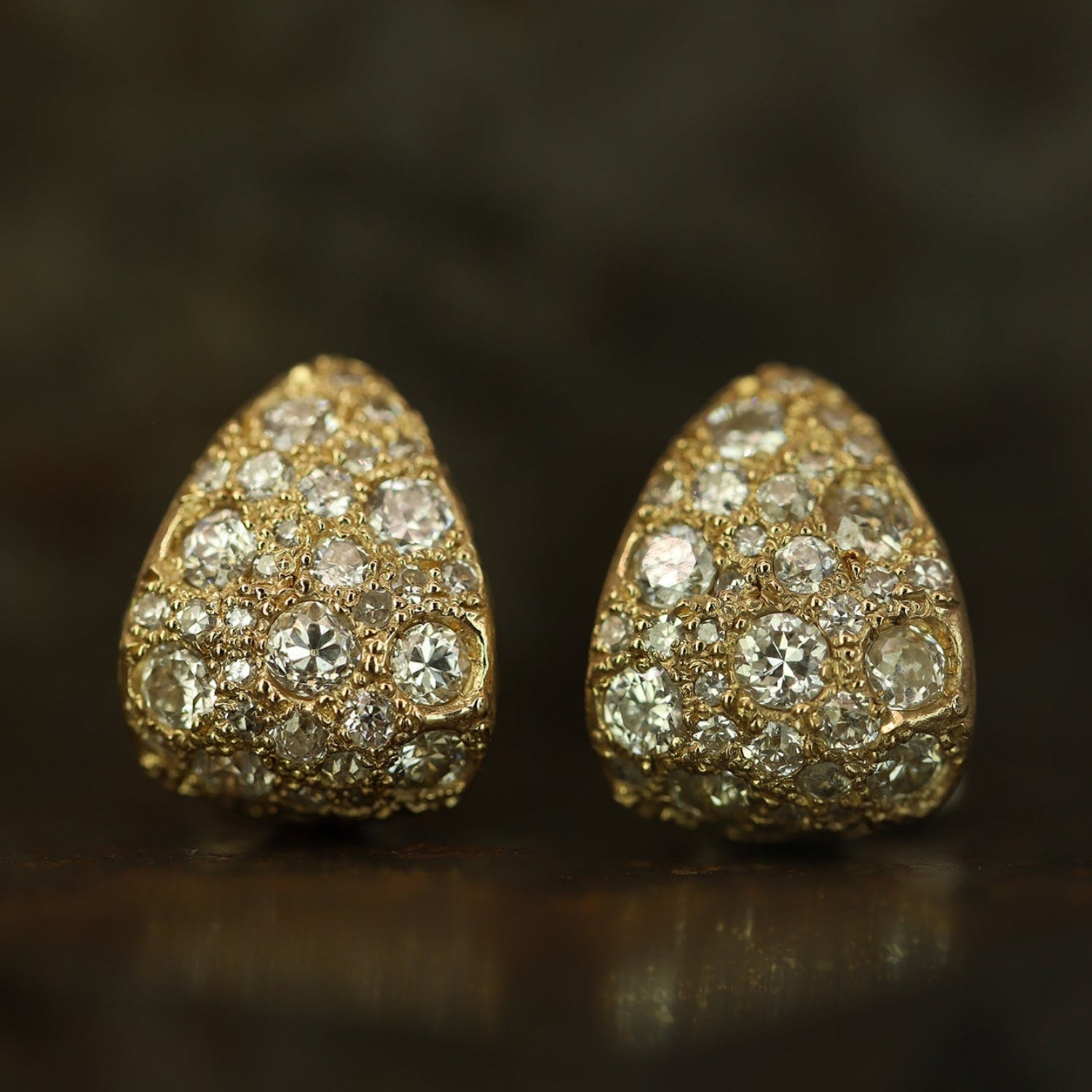 Ellis Mhairi Cameron - Pair of gold earrings with diamond accents on a dark background