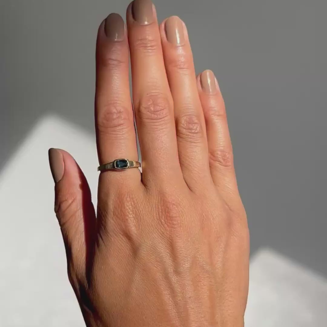 Dark sapphire ring on hand