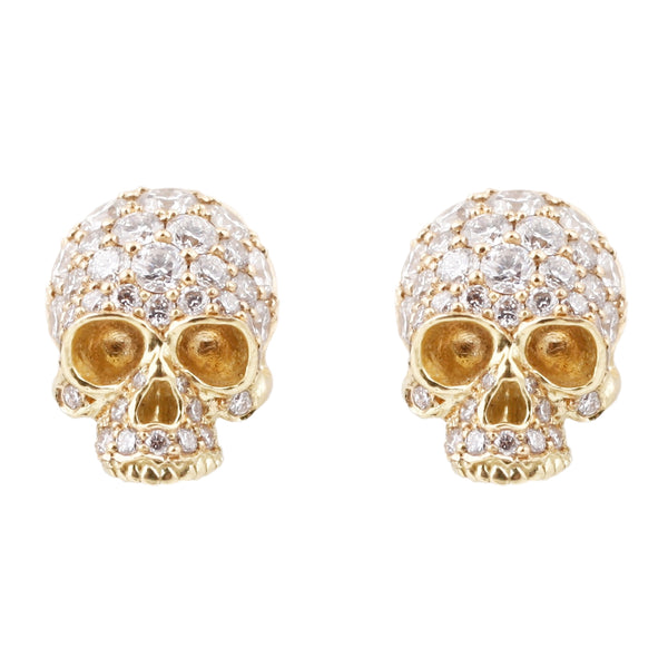 Anthony Lent 18k yellow gold skull studs covered in white pavé diamonds.